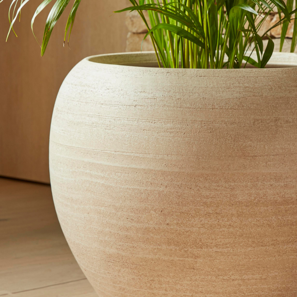 Close-up of the Amora Indoor Plant Pot in a neutral tone, highlighting its handcrafted texture and smooth curved design.