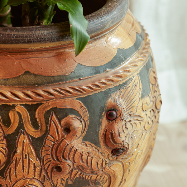 Up close shot of the Phaya Dragon indoor plant pot showcasing dragon carving and marble eyes