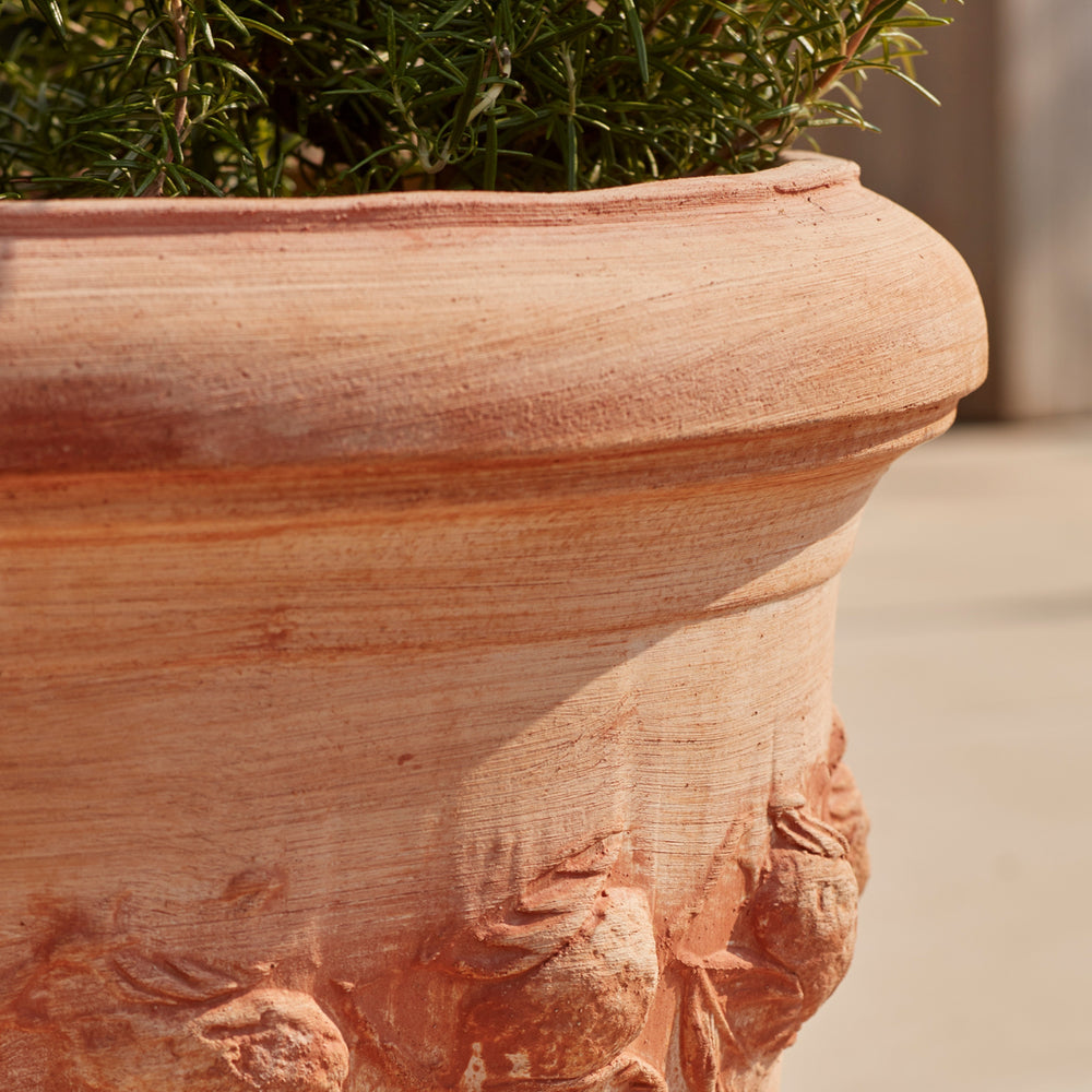 Close-up of the Sorrento Citrus Terracotta Pot’s hand-applied floral garland detailing, highlighting its kiln-fired terracotta texture. A weather-resistant, handcrafted planter for gardens and patios.