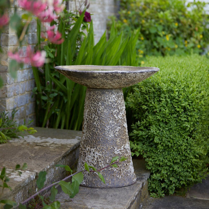 Side profile of the Ancient Salt Glaze Bird Bath, showcasing its elegant flared basin and textured, aged ceramic finish.